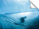 A behind the wave, underwater view of a surfer in the tube.