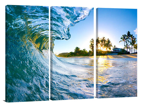 An ocean wave breaking onto the beach during sunrise, on the north shore of Oahu.