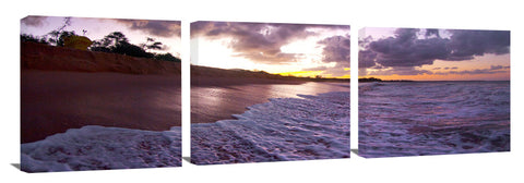 An ocean wave breaking onto the beach at Makena State Park, on the island of Maui in Hawaii.