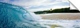 An ocean wave breaking onto the beach on the north shore.