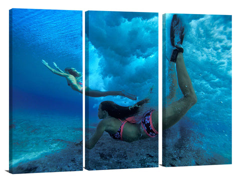 underwater view of girls swimming in the surf, north shore, Oahu