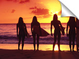 surfer girls silhouetted against setting sun, north shore, Oahu,