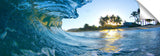 An ocean wave breaking onto the beach during sunrise, on the north shore of Oahu.