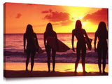surfer girls silhouetted against setting sun, north shore, Oahu,