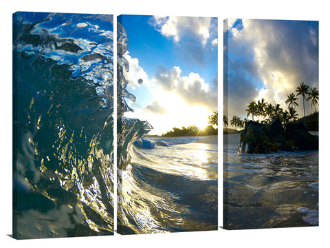 A wave breaking onto the beach during sunrise, on the north shore.