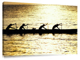 Hawaiian outrigger canoe silhouetted on a golden sea, north shor