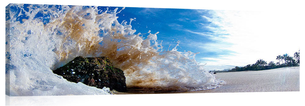 An ocean wave crashing against a rock, on the island of Oahu, Hawaii.