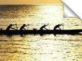 Hawaiian outrigger canoe silhouetted on a golden sea, north shor