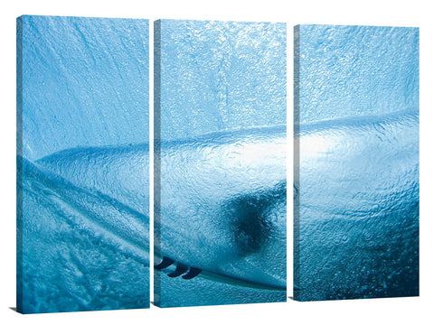 A behind the wave, underwater view of a surfer in the tube.