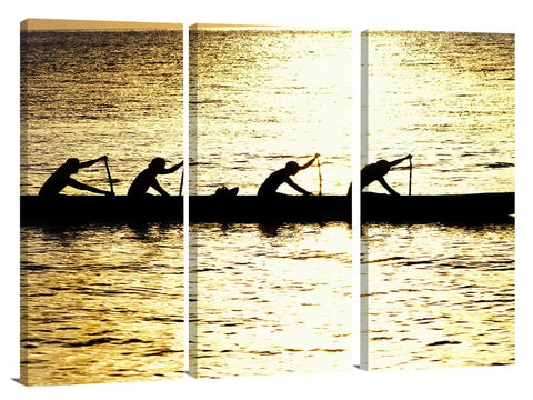 Hawaiian outrigger canoe silhouetted on a golden sea, north shor