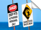 Dangerous surf warning signs at Pipeline on oahu's north shore.