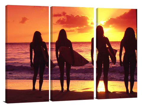 surfer girls silhouetted against setting sun, north shore, Oahu,