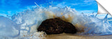 An ocean wave crashing against a rock, on the island of Oahu, Hawaii.