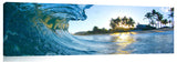 An ocean wave breaking onto the beach during sunrise, on the north shore of Oahu.